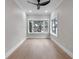 Well-lit bedroom featuring bright white trim, light hardwood floors and multiple windows at 1003 Oakdale St, Windermere, FL 34786