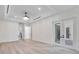 Spacious bedroom with French doors to the patio, tray ceiling and hardwood floors create a luxurious space at 1003 Oakdale St, Windermere, FL 34786