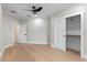 Bright, spacious bedroom with light wood floors, ceiling fan, closet with sliding doors, and neutral paint at 1003 Oakdale St, Windermere, FL 34786