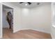 An inviting bedroom showcases hardwood floors, white trim, and a doorway that leads to a staircase at 1003 Oakdale St, Windermere, FL 34786