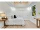 Bright bedroom with a tray ceiling, hardwood floors, and a large window view at 1003 Oakdale St, Windermere, FL 34786