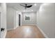 Simple bedroom with wood flooring, natural light, closet, and a ceiling fan at 1003 Oakdale St, Windermere, FL 34786