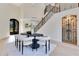 Elegant dining area featuring a statement table, stylish chairs, and a grand staircase at 1003 Oakdale St, Windermere, FL 34786