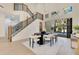 Bright dining room featuring an elegant table set with modern chairs and staircase at 1003 Oakdale St, Windermere, FL 34786