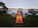 Long private dock on a tranquil lake with boat house provides the perfect spot for relaxing at 1003 Oakdale St, Windermere, FL 34786