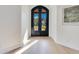 Inviting foyer with dark ornate double doors and light hardwood flooring, showcasing elegant design at 1003 Oakdale St, Windermere, FL 34786