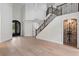 Grand foyer with decorative front door, staircase, and ample natural light, showcasing the home's entryway at 1003 Oakdale St, Windermere, FL 34786
