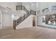 Elegant foyer with staircase, hardwood floors, and access to the pool area through a glass sliding door at 1003 Oakdale St, Windermere, FL 34786