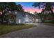 Beautiful two-story home with stone and stucco exterior and a paved driveway leading to the entrance at 1003 Oakdale St, Windermere, FL 34786