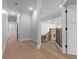 Hallway with wood floors, leading to a stairway with black rails at 1003 Oakdale St, Windermere, FL 34786