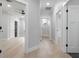 Hallway featuring wood flooring, neutral paint, and paneled doors at 1003 Oakdale St, Windermere, FL 34786