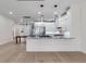 Modern kitchen with white cabinets, granite counters, and stainless steel appliances at 1003 Oakdale St, Windermere, FL 34786