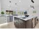 Bright kitchen featuring a central island with a sink and modern finishes, with a view to the backyard at 1003 Oakdale St, Windermere, FL 34786