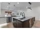 Modern kitchen features white cabinets, granite countertops, stainless steel appliances, and a large island with seating at 1003 Oakdale St, Windermere, FL 34786