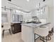 Modern kitchen with stainless steel appliances, a large island, and stylish bar stools at 1003 Oakdale St, Windermere, FL 34786