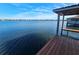 View from boat dock with covered area, ladders, and wood slats leading to open lake at 1003 Oakdale St, Windermere, FL 34786