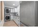 Laundry Room with stackable washer/dryer and granite countertops at 1003 Oakdale St, Windermere, FL 34786