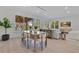 Bright living room flows into dining area with scenic views, light hardwood floors, and neutral furnishings at 1003 Oakdale St, Windermere, FL 34786