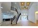 Bright open-concept living room with high ceilings, hardwood floors, and a staircase leading to the second floor at 1003 Oakdale St, Windermere, FL 34786