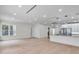 Open-concept living room with hardwood floors, white walls, and kitchen island with modern pendant lighting at 1003 Oakdale St, Windermere, FL 34786