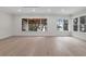 Spacious living room with hardwood floors, white walls, and large windows providing plenty of natural light at 1003 Oakdale St, Windermere, FL 34786