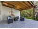 Outdoor kitchen under a covered patio with built-in grill and seating area at 1003 Oakdale St, Windermere, FL 34786