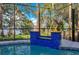 Screened pool with a tile water feature, fire bowls, and view of the lake at 1003 Oakdale St, Windermere, FL 34786