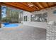 The inviting backyard pool with a waterfall feature, and covered patio for outdoor gatherings at 1003 Oakdale St, Windermere, FL 34786