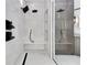 Modern walk-in shower featuring double rain shower heads and built-in bench at 1003 Oakdale St, Windermere, FL 34786