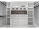 Organized walk-in closet featuring custom shelving, drawers, and ample storage space for clothing and accessories at 1003 Oakdale St, Windermere, FL 34786