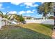 Private, fenced backyard with lush green grass and mature trees at 15321 Beamleigh Rd, Winter Garden, FL 34787