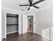 Bedroom boasts a ceiling fan, wood-look floors, closet, and an ensuite bathroom at 15321 Beamleigh Rd, Winter Garden, FL 34787
