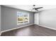 Bright bedroom features a modern ceiling fan, wood-look floors, and a sunlit window at 15321 Beamleigh Rd, Winter Garden, FL 34787