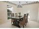 Bright dining room with a wood table, wicker chairs, and a chandelier at 1214 Hilltop Dr, Mount Dora, FL 32757