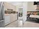 Kitchen with stainless steel appliances and a view into the dining room at 1214 Hilltop Dr, Mount Dora, FL 32757