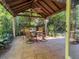 Relaxing patio features a table, chairs, and ceiling fan at 1214 Hilltop Dr, Mount Dora, FL 32757