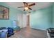 Light-filled bedroom with a ceiling fan, closet, and wood-look vinyl plank flooring at 3260 Se 32Nd Ct, Ocala, FL 34471