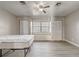 Bedroom featuring a ceiling fan, wood-look flooring, and a window seat between two closets at 3260 Se 32Nd Ct, Ocala, FL 34471