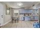 Cozy kitchen area with light blue cabinetry and stainless steel appliances at 3260 Se 32Nd Ct, Ocala, FL 34471