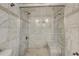 Luxurious tiled shower featuring dual shower heads and a built-in bench at 3260 Se 32Nd Ct, Ocala, FL 34471