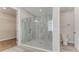 Bathroom featuring a glass-enclosed shower, tiled walls, and a separate toilet area at 1209 Cresswind Blvd, Deland, FL 32724
