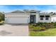 Charming single-story home with a two-car garage and a beautifully landscaped front yard at 1209 Cresswind Blvd, Deland, FL 32724
