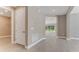 Hallway with wood floors that lead to a living room with sliding glass doors at 1209 Cresswind Blvd, Deland, FL 32724