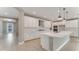 Spacious kitchen features white cabinets, a large island, and modern stainless steel appliances at 1209 Cresswind Blvd, Deland, FL 32724