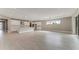 Spacious kitchen and living area featuring white cabinetry, stainless steel appliances, and large windows at 1209 Cresswind Blvd, Deland, FL 32724
