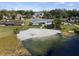 Aerial view of a waterfront home with private beach and lush landscaping at 3870 W Stillwood Ln, Lake Mary, FL 32746