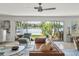 Bright living room with lake view, leather sofa, and sliding glass doors at 3870 W Stillwood Ln, Lake Mary, FL 32746