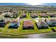 Aerial view of several houses with red tile roofs situated on a picturesque lake at 4363 Summer Breeze Way, Kissimmee, FL 34744