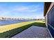 Backyard features a brick paver patio and expansive lake view, perfect for outdoor relaxation at 4363 Summer Breeze Way, Kissimmee, FL 34744