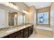 This bathroom features double vanity, granite countertop, soaking tub and walk-in shower at 4363 Summer Breeze Way, Kissimmee, FL 34744